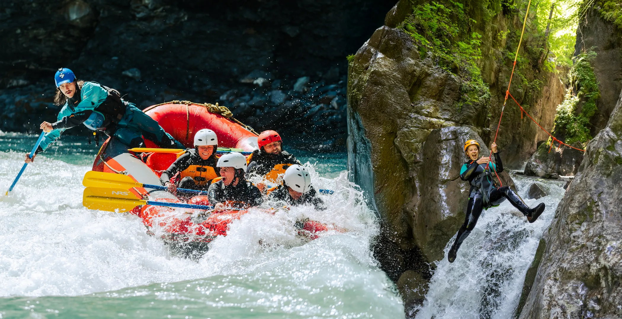 A rafting crew powering through white water beside a canyoner rappelling down a waterfall in a Swiss gorge near Interlaken